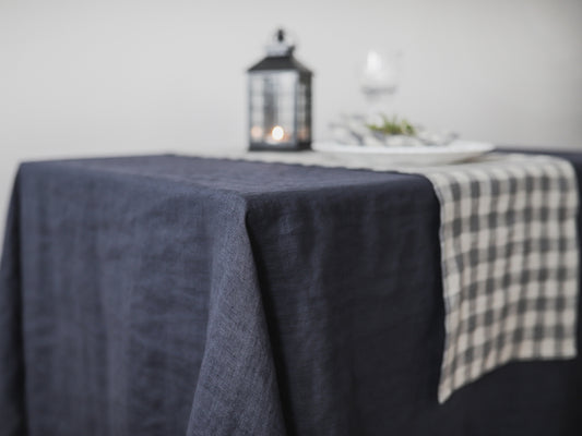 Charcoal gray linen tablecloth with a checkered runner 