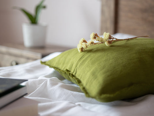 Eucalyptus Green pillow with flowers on a white bed