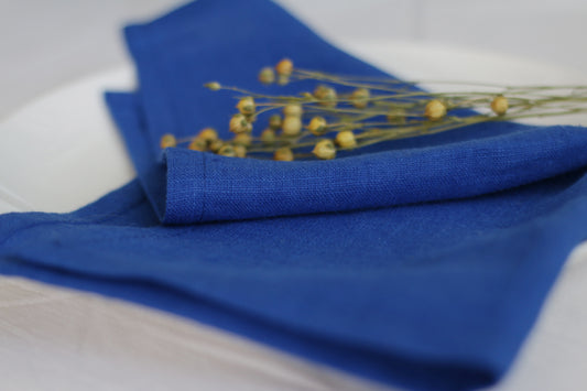Indigo blue napkin with  flowers on a white surface