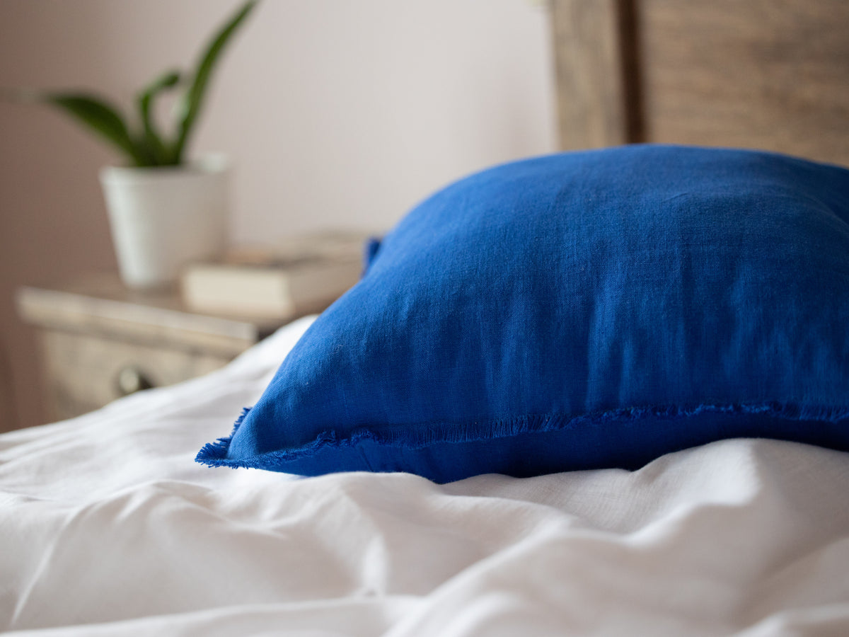 Blue pillow on a bed 