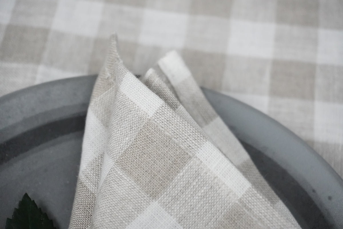 Plaid linen fabric napkin on a checkered tablecloth