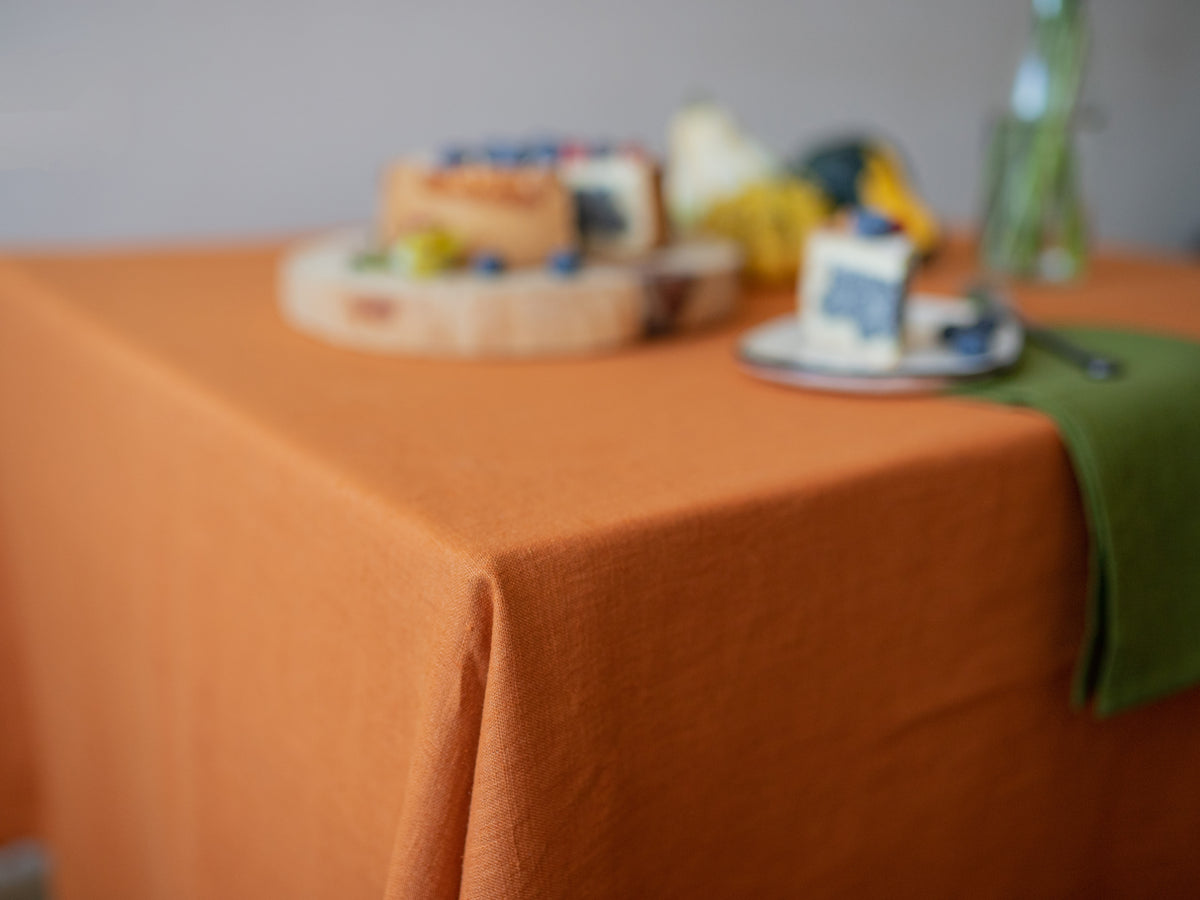 Orange linen  tablecloth on a table 